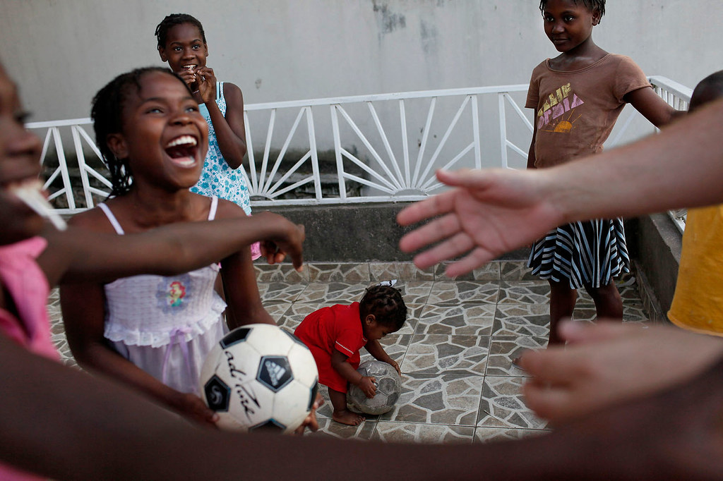 children laughing and paying soccer